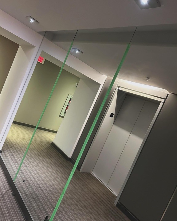 Full-height wall mirrors, condo corridor